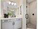 Modern bathroom features a glass-enclosed shower, sleek vanity, and stylish black fixtures and accents at 4405 W Euclid Ave, Tampa, FL 33629