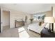 Bright bedroom with soft carpet, large windows, and elegant furnishings, leading to an adjoining bathroom at 4405 W Euclid Ave, Tampa, FL 33629