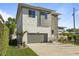 Two-story home featuring a gray garage door and well-manicured landscaping at 4405 W Euclid Ave, Tampa, FL 33629