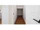 Hallway with hardwood floors leading to an open space for storage, illuminated by natural light at 4405 W Euclid Ave, Tampa, FL 33629