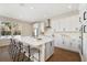 Modern kitchen featuring white cabinetry, stainless steel appliances, and a large central island with four chairs at 4405 W Euclid Ave, Tampa, FL 33629