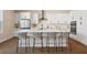 Modern kitchen featuring white cabinetry, stainless steel appliances, and a large central island at 4405 W Euclid Ave, Tampa, FL 33629