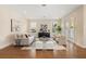 Bright living room with hardwood floors, modern furnishings, neutral tones, and French doors at 4405 W Euclid Ave, Tampa, FL 33629