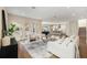 Open-concept living room with hardwood floors, neutral tones, and seamlessly connected to the kitchen and dining area at 4405 W Euclid Ave, Tampa, FL 33629