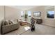 Bright, carpeted living room showcasing contemporary decor, large windows, and a comfortable seating arrangement at 4405 W Euclid Ave, Tampa, FL 33629