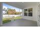 Covered patio with white columns, concrete floors and fenced-in backyard view at 4405 W Euclid Ave, Tampa, FL 33629