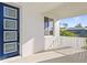 Home front porch with a modern blue door, white walls and railing, and an exterior view at 4405 W Euclid Ave, Tampa, FL 33629