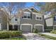 Charming exterior of two-story townhome with neat landscaping, and attached two-car garage at 4723 Barnstead Dr, Riverview, FL 33578