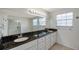 Bathroom with a large mirror, a double sink, and granite countertops at 5014 Sterling Manor Dr, Tampa, FL 33647