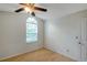 Bedroom features a ceiling fan, arched window, and wood floors at 5014 Sterling Manor Dr, Tampa, FL 33647