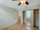 Bright bedroom with wood floors, closet, and ensuite bathroom entrance at 5014 Sterling Manor Dr, Tampa, FL 33647