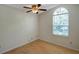 Bedroom with wood floors, a ceiling fan, and an arched window at 5014 Sterling Manor Dr, Tampa, FL 33647