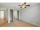 Sunny bedroom boasts wood flooring, a closet, and ensuite bathroom entrance at 5014 Sterling Manor Dr, Tampa, FL 33647