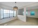 Open-concept dining room featuring large windows and a modern light fixture at 5014 Sterling Manor Dr, Tampa, FL 33647