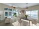 Airy dining area boasts large windows, a modern light fixture, and comfortable seating at 5014 Sterling Manor Dr, Tampa, FL 33647