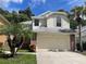 Charming two-story home with lush landscaping and an attached two-car garage at 5014 Sterling Manor Dr, Tampa, FL 33647