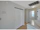 Upstairs hallway has wood floors and a closet with sliding doors at 5014 Sterling Manor Dr, Tampa, FL 33647