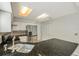 Kitchen with stainless steel refrigerator, white cabinets, granite countertops, and modern lighting fixtures at 5014 Sterling Manor Dr, Tampa, FL 33647