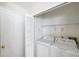 Laundry room featuring a washing machine and dryer along with a folding door for storage at 5014 Sterling Manor Dr, Tampa, FL 33647