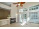 Cozy living room with fireplace, ceiling fan, and access to the backyard at 5014 Sterling Manor Dr, Tampa, FL 33647