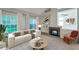 Bright living room with a modern fireplace, large windows, and cozy furniture at 5014 Sterling Manor Dr, Tampa, FL 33647