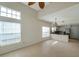 Bright living room with high ceilings, tile floors, and large windows allowing for plenty of natural light at 5014 Sterling Manor Dr, Tampa, FL 33647