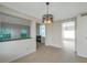 Open-concept dining room featuring large windows and a modern light fixture at 5014 Sterling Manor Dr, Tampa, FL 33647