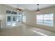 Bright living room with tile floors, large windows, ceiling fan, and views to the patio at 5014 Sterling Manor Dr, Tampa, FL 33647