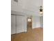 Bright main bedroom boasts wood floors, a ceiling fan, closet, and bathroom entrance at 5014 Sterling Manor Dr, Tampa, FL 33647