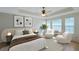 Stylized primary bedroom features modern decor, light, and a spacious layout at 5014 Sterling Manor Dr, Tampa, FL 33647