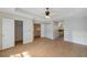 Spacious main bedroom features wood flooring, walk-in closets, and ensuite bathroom access at 5014 Sterling Manor Dr, Tampa, FL 33647