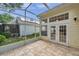 Relax on this screened patio with tiled flooring and views of the backyard at 5014 Sterling Manor Dr, Tampa, FL 33647