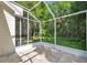 Screened in back porch with tile flooring and access to backyard at 5014 Sterling Manor Dr, Tampa, FL 33647