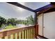 Balcony with a scenic lake view, enhanced by lush greenery and a clear sky at 5026 Water Oak Dr # 220, Bradenton, FL 34207