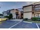 Exterior of a condo building with a parking lot, wooden stairs, and plants at 5026 Water Oak Dr # 220, Bradenton, FL 34207