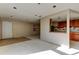 Open-concept living room with view into the kitchen; ready to be remodeled at 5026 Water Oak Dr # 220, Bradenton, FL 34207