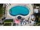 Aerial view of a kidney-shaped pool with patio furniture and an umbrella at 5026 Water Oak Dr # 220, Bradenton, FL 34207