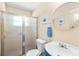 Bright bathroom with frosted glass shower door, blue vanity, and decor at 509 Faithway Dr, Seffner, FL 33584