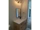 Bathroom with quartz countertop, light wood cabinets, black faucet, and gold fixtures at 5166 Deltona Blvd, Spring Hill, FL 34606