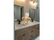 Elegant bathroom featuring double sinks, quartz countertops, and decorative gold framed mirrors at 5166 Deltona Blvd, Spring Hill, FL 34606