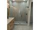 Modern bathroom featuring a glass-enclosed shower, stylish vanity, contemporary fixtures, and attractive floor tiles at 5166 Deltona Blvd, Spring Hill, FL 34606