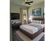 Inviting bedroom with a well-made bed, modern decor, large windows, and a calming ambiance at 5166 Deltona Blvd, Spring Hill, FL 34606