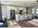 A stylish kitchen with modern appliances, pendant lighting, and an open concept to the living room at 5166 Deltona Blvd, Spring Hill, FL 34606