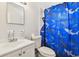 Bathroom featuring a sink, toilet, and playful shark-themed shower curtain at 5208 S 82Nd St, Tampa, FL 33619