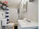 Functional bathroom with a white vanity, toilet, tile surround shower, and modern fixtures at 5208 S 82Nd St, Tampa, FL 33619