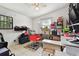 A versatile spare room featuring a red styling chair, neutral walls, and ample shelving at 5208 S 82Nd St, Tampa, FL 33619