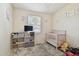 Bright Bedroom with modern crib, playful wall decor, and soft, cozy rug at 5208 S 82Nd St, Tampa, FL 33619