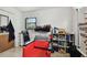 An adjustable styling chair sits in this room with a built-in shelving unit and a window at 5208 S 82Nd St, Tampa, FL 33619