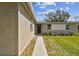 Side view of a quaint single-story home featuring a walkway leading to the front door at 5208 S 82Nd St, Tampa, FL 33619