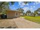View of the exterior with a long driveway leading to the side of the house and fenced yards at 5208 S 82Nd St, Tampa, FL 33619